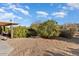 Backyard with gravel, shrubs, and a patio at 13907 W Gable Hill Dr, Sun City West, AZ 85375
