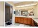 Bathroom with double sinks and a shower at 13907 W Gable Hill Dr, Sun City West, AZ 85375