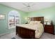 Bedroom with a leafy patterned comforter and ceiling fan at 13907 W Gable Hill Dr, Sun City West, AZ 85375