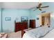 Bright bedroom with wood furniture and a ceiling fan at 13907 W Gable Hill Dr, Sun City West, AZ 85375