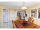 Bright dining area with wood table and chairs, view of kitchen at 13907 W Gable Hill Dr, Sun City West, AZ 85375