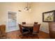 Wood circular dining table with four chairs in a well lit area at 13907 W Gable Hill Dr, Sun City West, AZ 85375