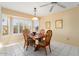 Cozy dining area with wood table and chairs near a bright kitchen at 13907 W Gable Hill Dr, Sun City West, AZ 85375
