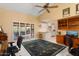 Home office with wood desk, two chairs, and built-in shelving at 13907 W Gable Hill Dr, Sun City West, AZ 85375
