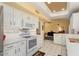 White kitchen features stainless steel appliances and an eat-in island at 13907 W Gable Hill Dr, Sun City West, AZ 85375