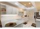 Modern kitchen with white cabinets and a large island at 13907 W Gable Hill Dr, Sun City West, AZ 85375