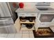 Pot and pan drawers in white kitchen cabinets at 13907 W Gable Hill Dr, Sun City West, AZ 85375