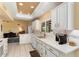 Bright kitchen with white cabinets, granite countertops, and stainless steel appliances at 13907 W Gable Hill Dr, Sun City West, AZ 85375