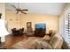 Spacious living room with a dining area and wood flooring at 13907 W Gable Hill Dr, Sun City West, AZ 85375