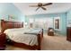 Main bedroom with wood bed frame and window shutters at 13907 W Gable Hill Dr, Sun City West, AZ 85375