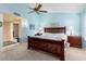 Main bedroom with wood bed frame and ensuite bathroom access at 13907 W Gable Hill Dr, Sun City West, AZ 85375