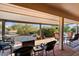 Covered patio with fire pit and seating area at 13907 W Gable Hill Dr, Sun City West, AZ 85375