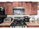 Close-up of kitchen featuring stainless steel appliances and granite countertops at 14765 W Alexandria Way, Surprise, AZ 85379