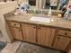 Bathroom with granite countertop, single sink, and wood cabinets at 14950 W Mountain View Blvd # 5112, Surprise, AZ 85374