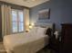 Bedroom with queen bed, window with shutters, and nice artwork at 14950 W Mountain View Blvd # 5112, Surprise, AZ 85374