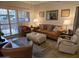 Spacious living room featuring leather couches and a large window at 14950 W Mountain View Blvd # 5112, Surprise, AZ 85374
