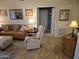 Relaxing living room with leather couch, recliner, and tiled floors at 14950 W Mountain View Blvd # 5112, Surprise, AZ 85374
