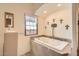 Bathroom with soaking tub, tile surround and decorative elements at 16241 E Trevino Dr, Fountain Hills, AZ 85268