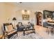 Comfortable living room with tile floors, a decorative fireplace, and an arched doorway at 16241 E Trevino Dr, Fountain Hills, AZ 85268