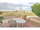 Outdoor patio with table and chairs, desert landscaping and a view of the backyard at 1716 S 141St Pl, Gilbert, AZ 85295