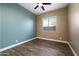 A neutral-toned bedroom featuring wood-look flooring and a ceiling fan at 1890 W Wisteria Dr, Chandler, AZ 85248