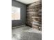 Modern bedroom featuring rustic wood accent wall and a bright window for natural light at 1890 W Wisteria Dr, Chandler, AZ 85248