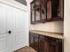 Butler's pantry with granite countertops, custom cabinets, and a doorway at 1890 W Wisteria Dr, Chandler, AZ 85248