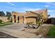 Exterior elevation of the home featuring an attached two-car garage and desert landscaping at 1890 W Wisteria Dr, Chandler, AZ 85248