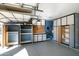Well-organized garage with installed storage cabinets and epoxy flooring at 1890 W Wisteria Dr, Chandler, AZ 85248