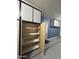 Interior view of a garage cabinet with adjustable shelves and a light wood grain finish for storage convenience at 1890 W Wisteria Dr, Chandler, AZ 85248