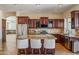 Kitchen boasts granite island, stainless steel appliances, and dark wood cabinets at 1890 W Wisteria Dr, Chandler, AZ 85248