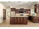 Spacious kitchen with granite countertops, stainless steel appliances, and custom cabinets at 1890 W Wisteria Dr, Chandler, AZ 85248