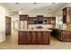 Well-equipped kitchen featuring a central island, stainless steel appliances, and decorative backsplash at 1890 W Wisteria Dr, Chandler, AZ 85248