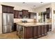 Bright kitchen featuring a large island, modern appliances, and wooden cabinets at 1890 W Wisteria Dr, Chandler, AZ 85248