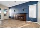 Living room with a blue accent wall, fireplace, and tile floors at 1890 W Wisteria Dr, Chandler, AZ 85248