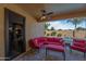 Covered patio with red seating, ceiling fan, and view of pool at 1890 W Wisteria Dr, Chandler, AZ 85248