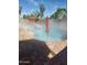 Refreshing pool area with red umbrellas and dog float, ideal for relaxation and outdoor fun at 1890 W Wisteria Dr, Chandler, AZ 85248