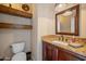 Elegant powder room featuring a granite vanity and decorative mirror at 1890 W Wisteria Dr, Chandler, AZ 85248