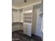 Bright, well-organized walk-in closet with white shelving and drawers at 1890 W Wisteria Dr, Chandler, AZ 85248