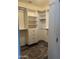 Organized walk-in closet featuring white shelving, drawers, and hanging rods for optimal storage at 1890 W Wisteria Dr, Chandler, AZ 85248