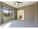 Primary bedroom with ceiling fan and access to bathroom at 19539 N 260Th Ln, Buckeye, AZ 85396