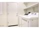 Laundry room with washer, dryer, and shelving at 19539 N 260Th Ln, Buckeye, AZ 85396