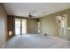Spacious living room with carpet, ceiling fan and access to backyard at 19539 N 260Th Ln, Buckeye, AZ 85396