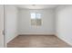 Empty bedroom with wood-look tile floors and a window at 23256 W Miami St, Buckeye, AZ 85326