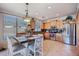 Charming kitchen featuring a dining table, stainless steel appliances, and tile flooring at 261 N Nash Way, Chandler, AZ 85225