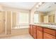 Bright bathroom showcasing a tiled shower, soaking tub, and a double sink vanity at 263 W Rosemary Dr, Chandler, AZ 85248