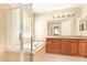 Bright bathroom featuring a glass-enclosed shower, soaking tub, and granite double vanity at 263 W Rosemary Dr, Chandler, AZ 85248