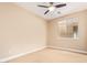 This carpeted bedroom features a ceiling fan and a window with lots of natural light at 263 W Rosemary Dr, Chandler, AZ 85248