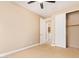 This carpeted bedroom includes a closet and a door that leads to the laundry room at 263 W Rosemary Dr, Chandler, AZ 85248