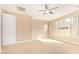This spacious bedroom features neutral tones and a ceiling fan for added comfort at 263 W Rosemary Dr, Chandler, AZ 85248